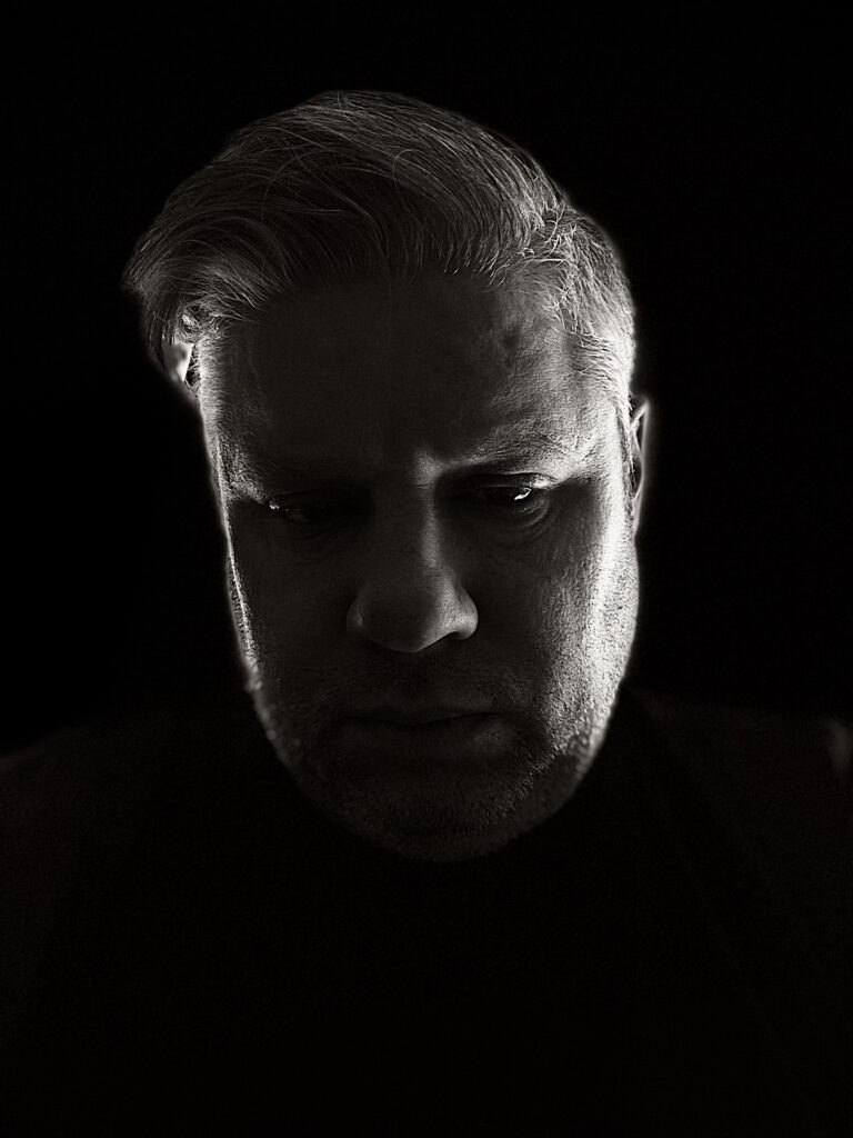 Headshot against black background